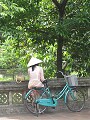Vietnamese woman with bike. Tam Coc, Vietnam